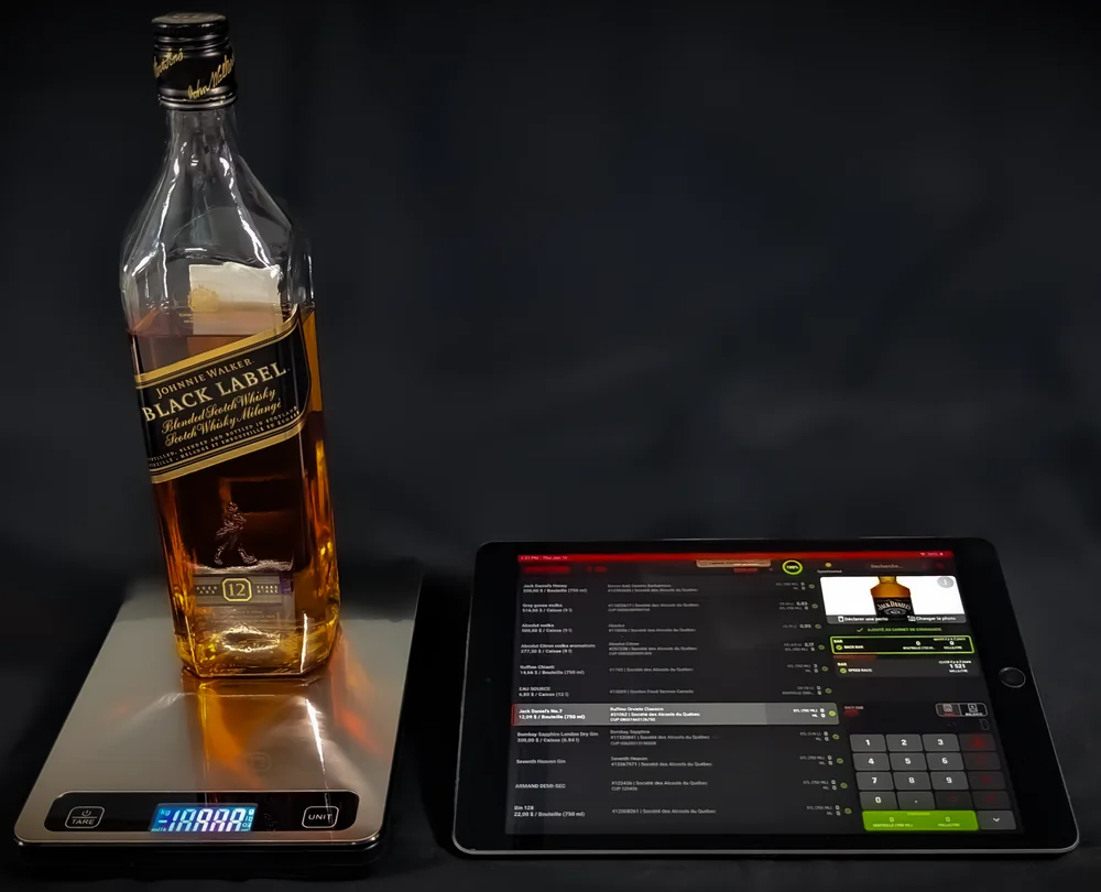 A bottle on the RESTOCK Scale beside a tablet running the RESTOCK inventory app